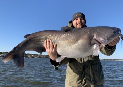 A man holding a large fish in his hands.